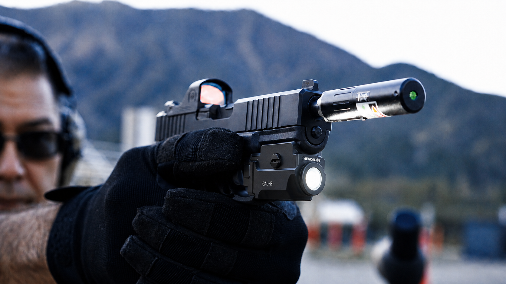 man aiming shotgun with tactical weapon light attached for shooting training